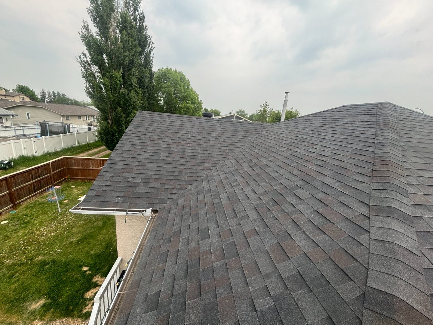 Completed dark hip roof on residential home near Ebenezer Saskatchewan